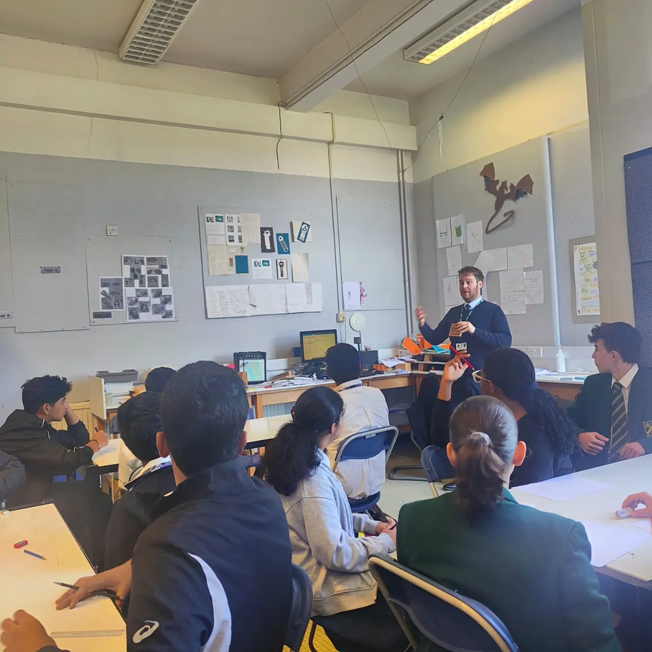 Students learning with a teacher in a British classroom