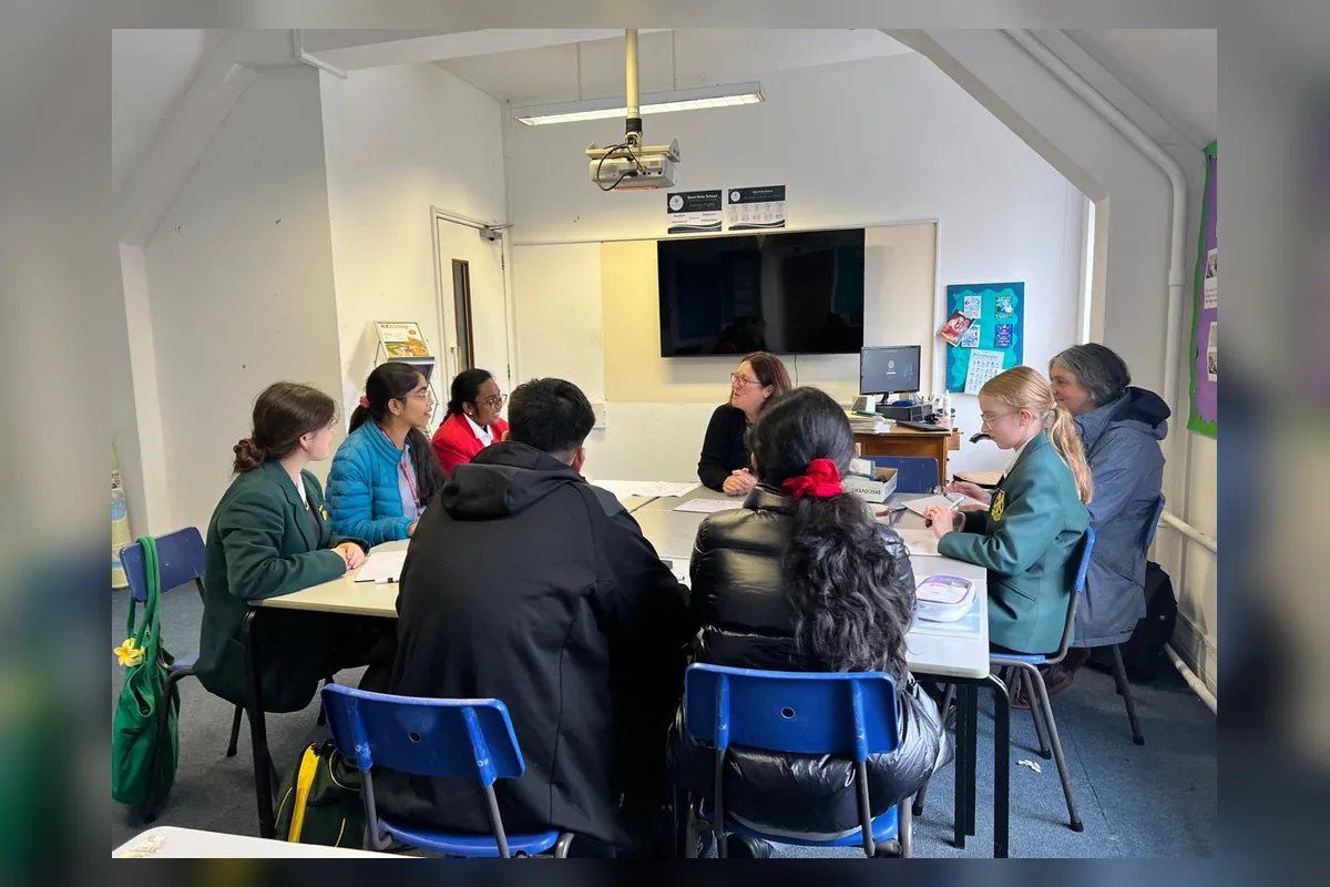 Students taking part in a collaborative research discussion
